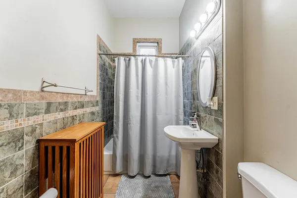 a bathroom with a sink a mirror and a shower