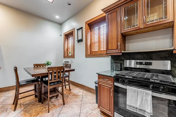 a kitchen with stainless steel appliances granite countertop a stove a sink and a microwave