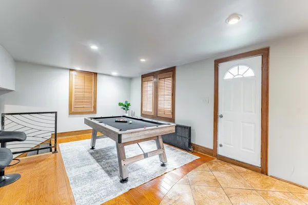 a room with furniture pool table and windows