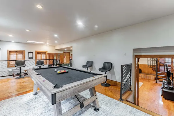 a living room with furniture a flat screen tv and a table