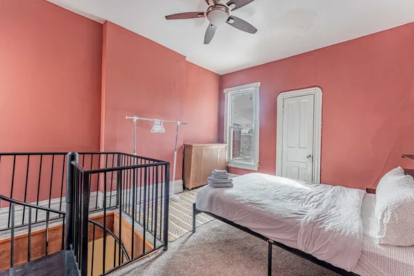 a bedroom with a bed and a chandelier