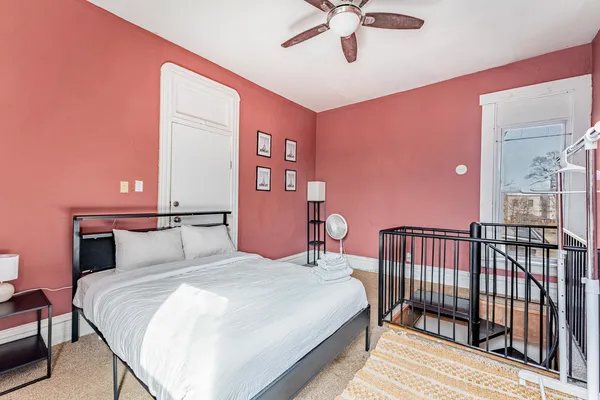 a bedroom with a bed and a chandelier