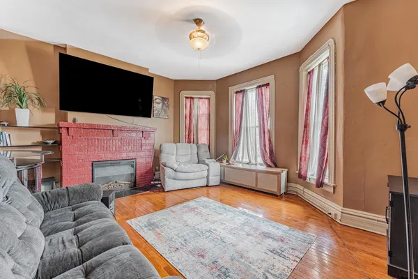 a living room with furniture fireplace and flat screen tv