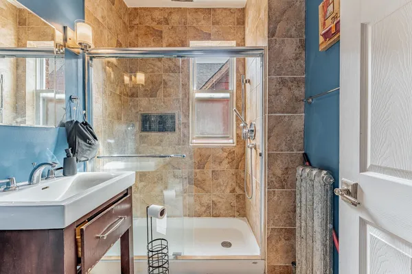 a bathroom with a shower and a sink