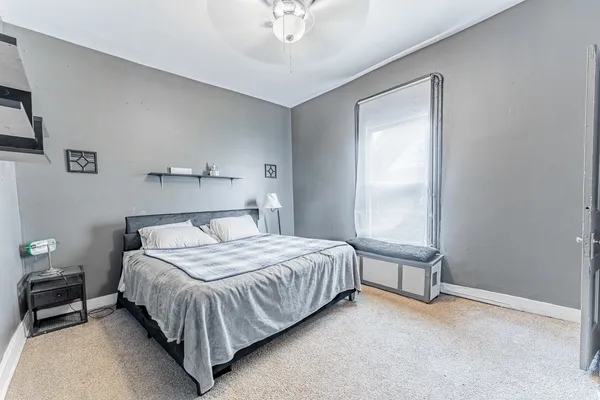 a bedroom with a bed and a window