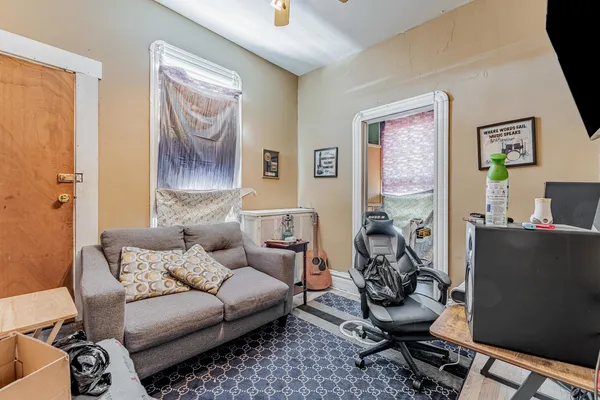 a living room with furniture a couch and a window