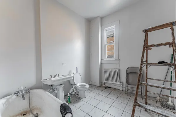 a bench sitting in a bathtub next to a window
