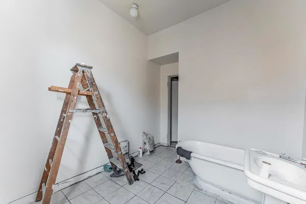 a view of a room with wooden floor and door