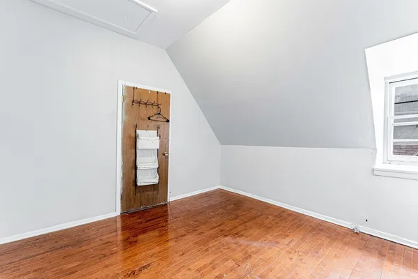 a living room with hard wood floors and a window