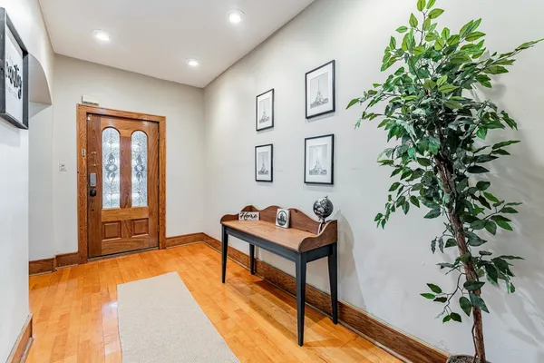 a living room with furniture plant and a window