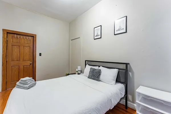 a bedroom with a bed and cabinets
