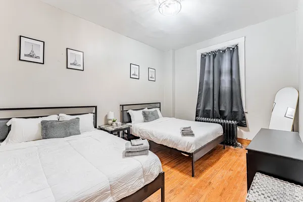 a bedroom with two beds and a table