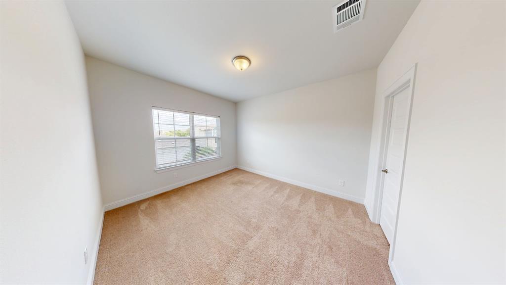601 C-Bar Ranch Trail, Unit 27 Cedar Park, TX 78613 - Photo 16 of 29 Carpeted room featuring a large window, neutral wall paint, white trim, and a ceiling-mounted light fixture