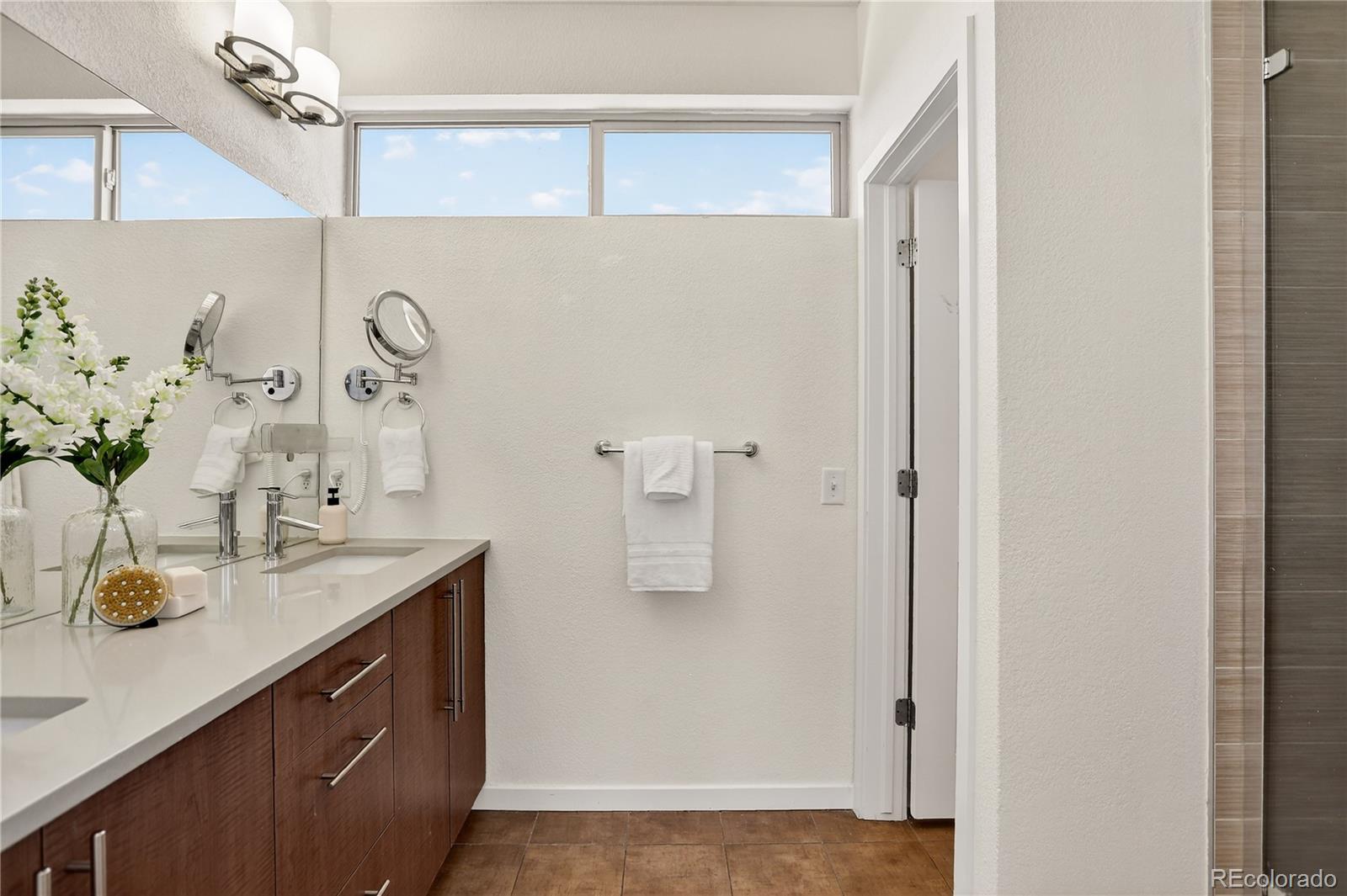 2130 Clay Street Denver, CO 80211 - Photo 15 of 22 a bathroom with a granite countertop sink a mirror and shower