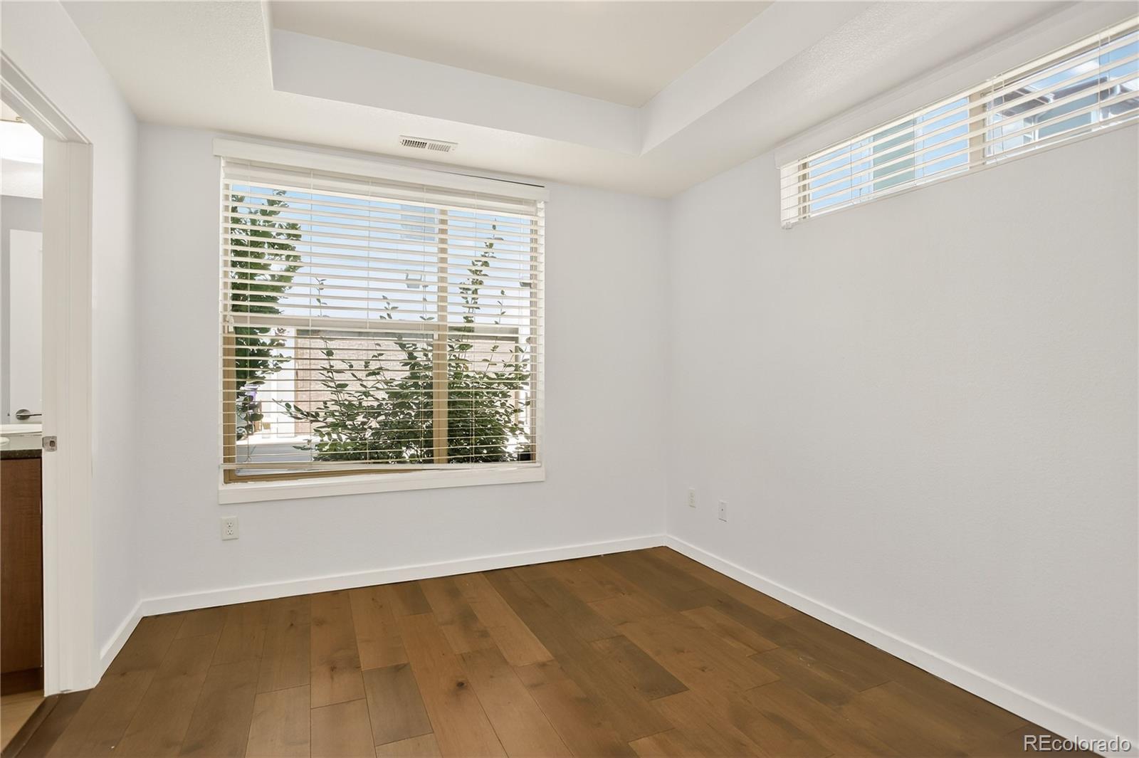 2130 Clay Street Denver, CO 80211 - Photo 2 of 22 a view of an empty room with wooden floor and a window