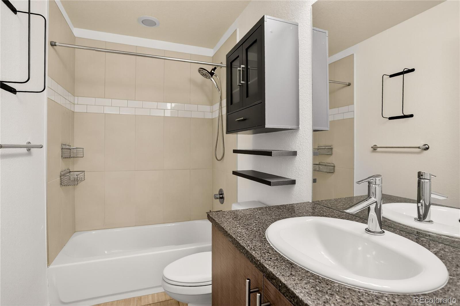 2130 Clay Street Denver, CO 80211 - Photo 3 of 22 a bathroom with a granite countertop sink a toilet and shower