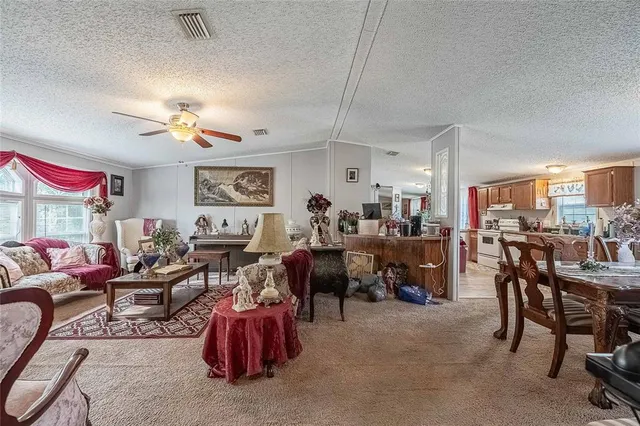 a living room with lots of furniture and lots of painting on the wall