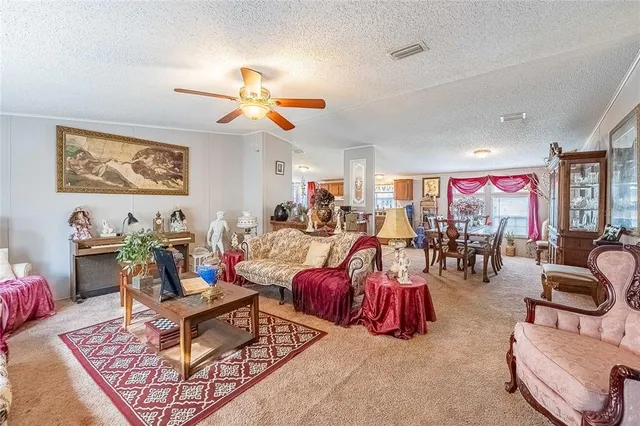 a living room with lots of furniture and view of pool