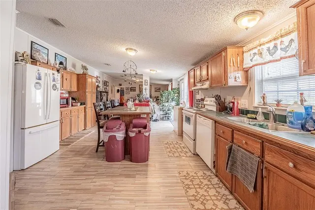 a kitchen with stainless steel appliances granite countertop a refrigerator a stove top oven and cabinets