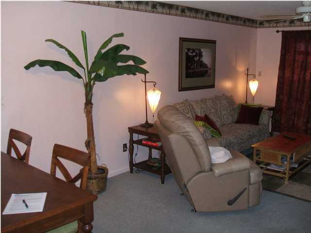 909 Santa Rosa Boulevard, Unit 526 Fort Walton Beach, FL 32548 - Photo 4 of 8 a living room with furniture and a potted plant
