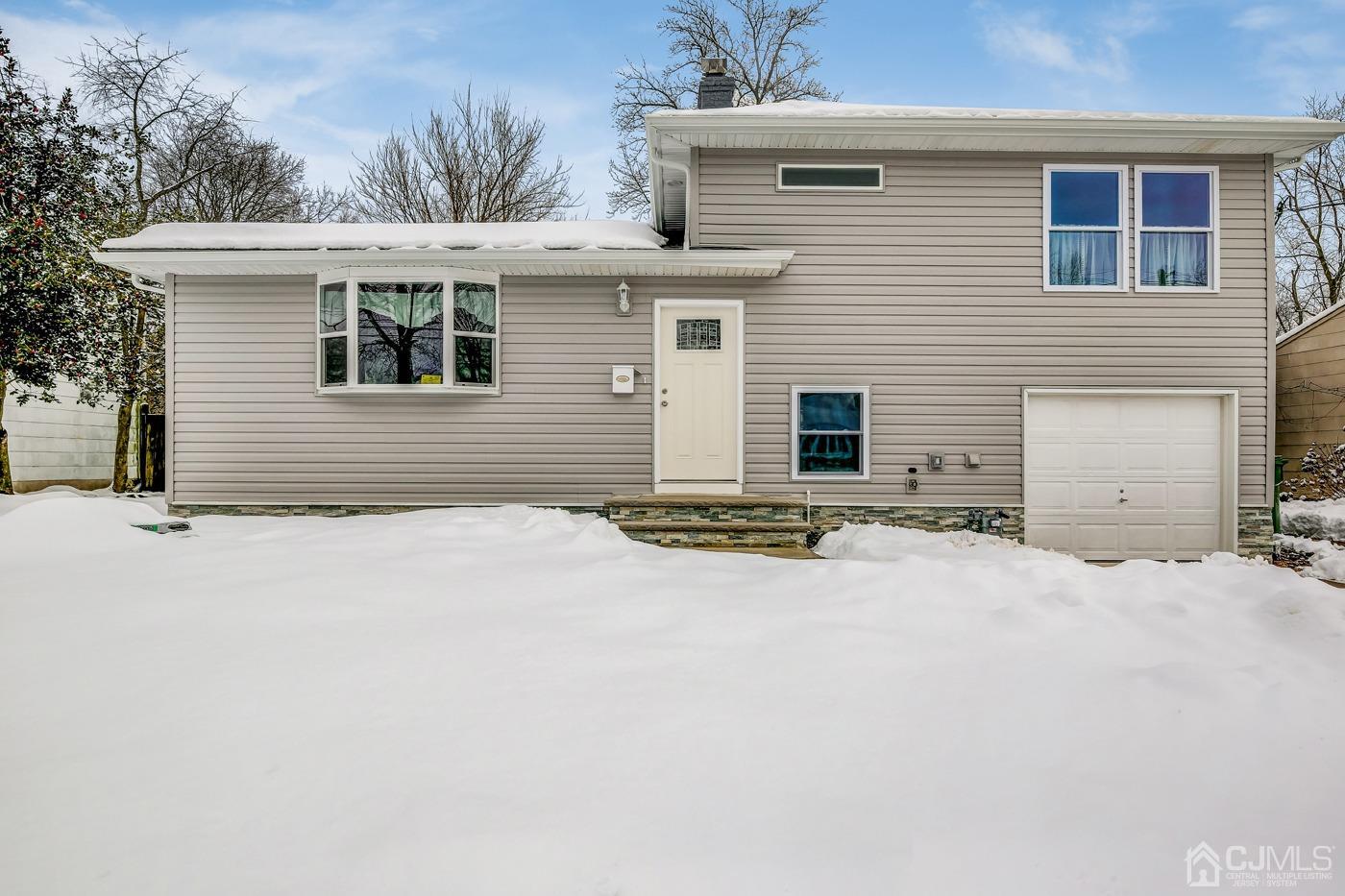 59 Stony Road Edison, NJ 08817 - Photo 1 of 27 a front view of a house with a yard