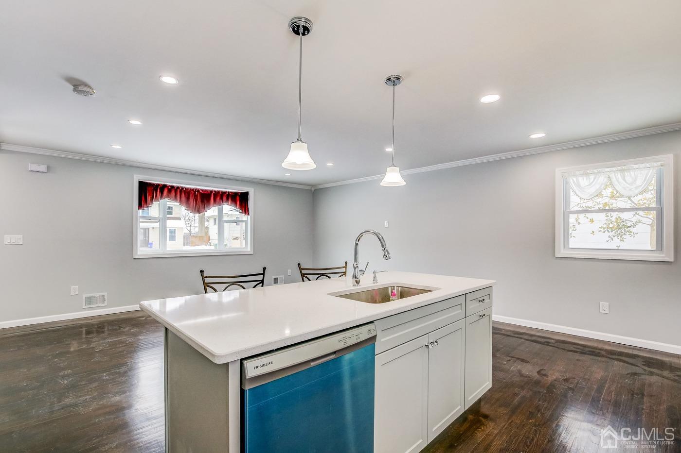 59 Stony Road Edison, NJ 08817 - Photo 11 of 27 a view of a kitchen island a sink stainless steel appliances and wooden floor