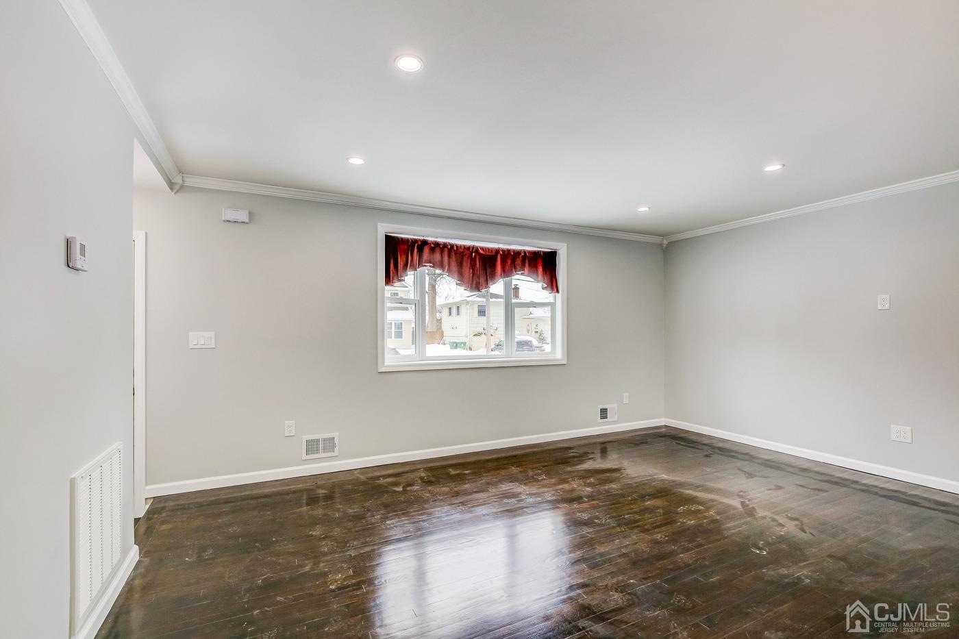 59 Stony Road Edison, NJ 08817 - Photo 12 of 27 an empty room with wooden floor and window