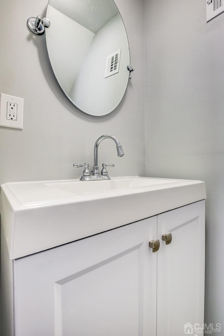 59 Stony Road Edison, NJ 08817 - Photo 18 of 27 a bathroom with a sink and a mirror