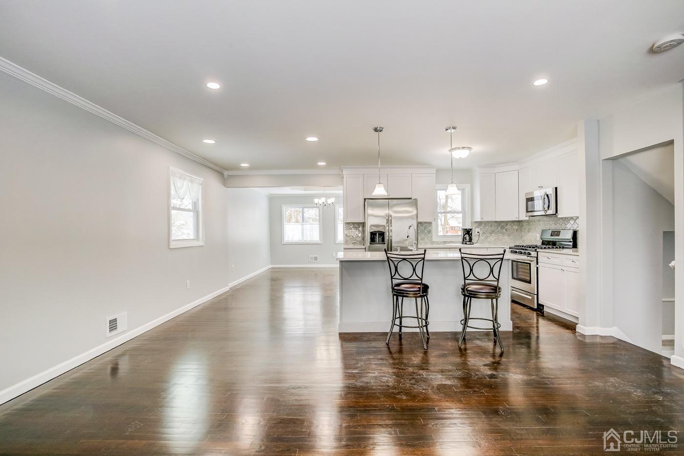 59 Stony Road Edison, NJ 08817 - Photo 4 of 27 a view of kitchen with cabinets and wooden floor