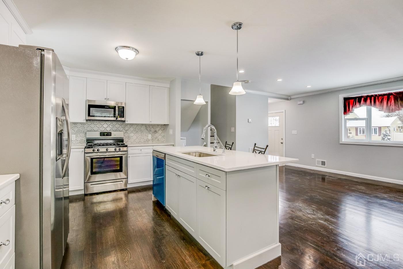 59 Stony Road Edison, NJ 08817 - Photo 8 of 27 a kitchen with a sink stainless steel appliances and cabinets