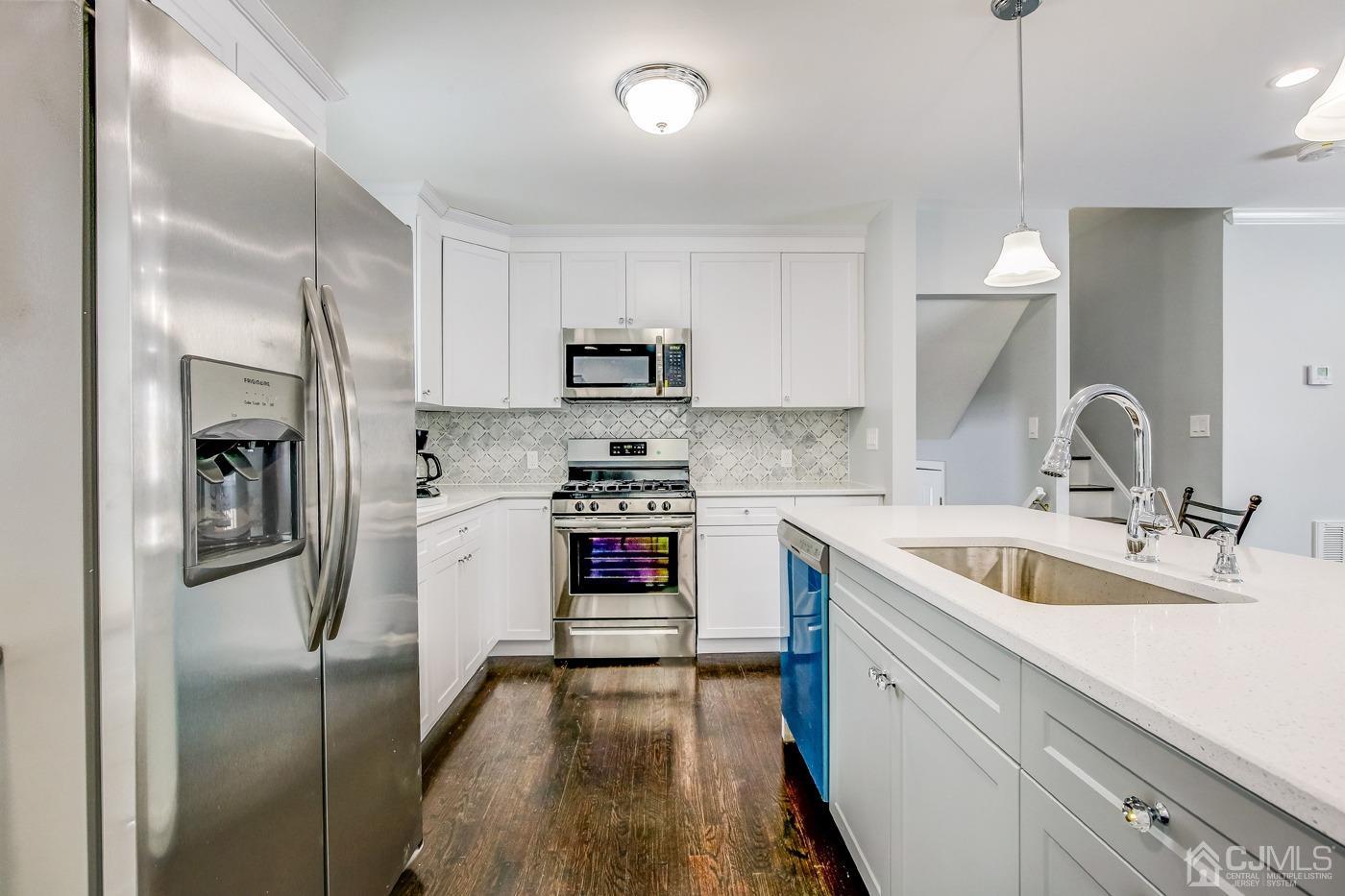 59 Stony Road Edison, NJ 08817 - Photo 9 of 27 a kitchen with a sink cabinets and stainless steel appliances