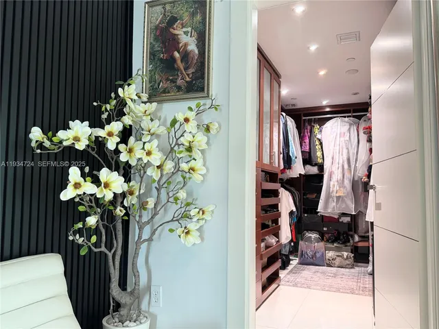 a vase of flowers sitting on a floor