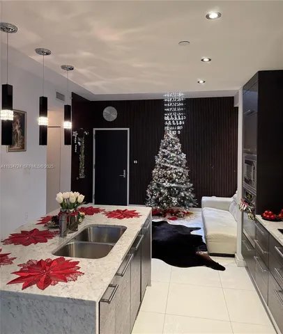 a kitchen with a sink a refrigerator and a stove