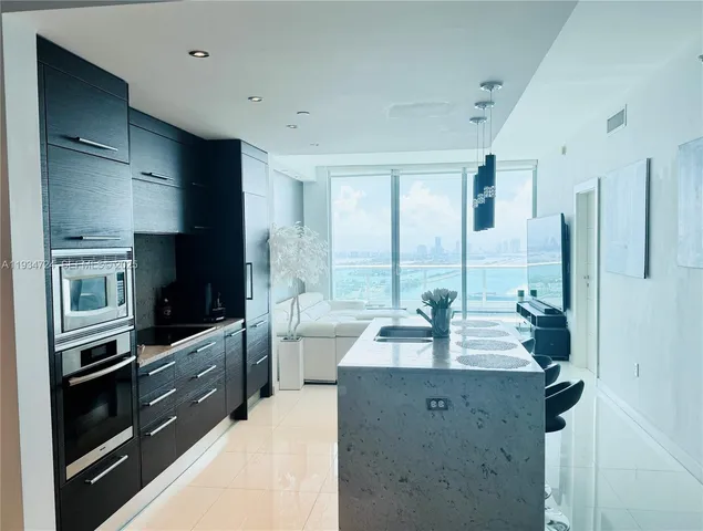a kitchen with stainless steel appliances a sink and a refrigerator