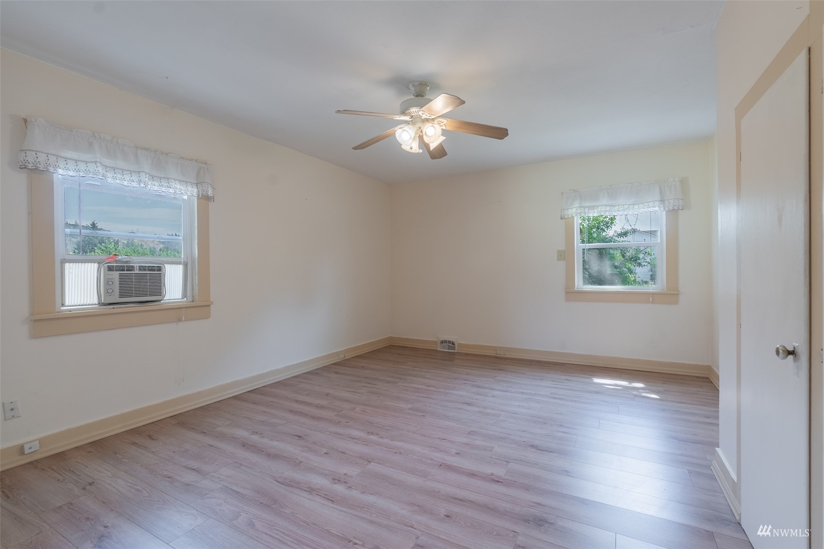 5415 Parker Road East Sumner, WA 98390 - Photo 14 of 27 a view of an empty room with wooden floor and a window