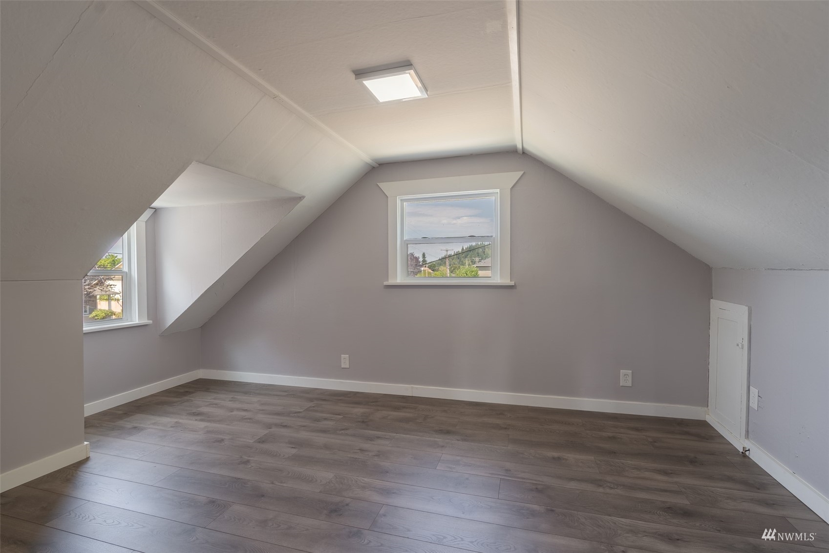 5415 Parker Road East Sumner, WA 98390 - Photo 17 of 27 a view of an empty room with wooden floor and a window