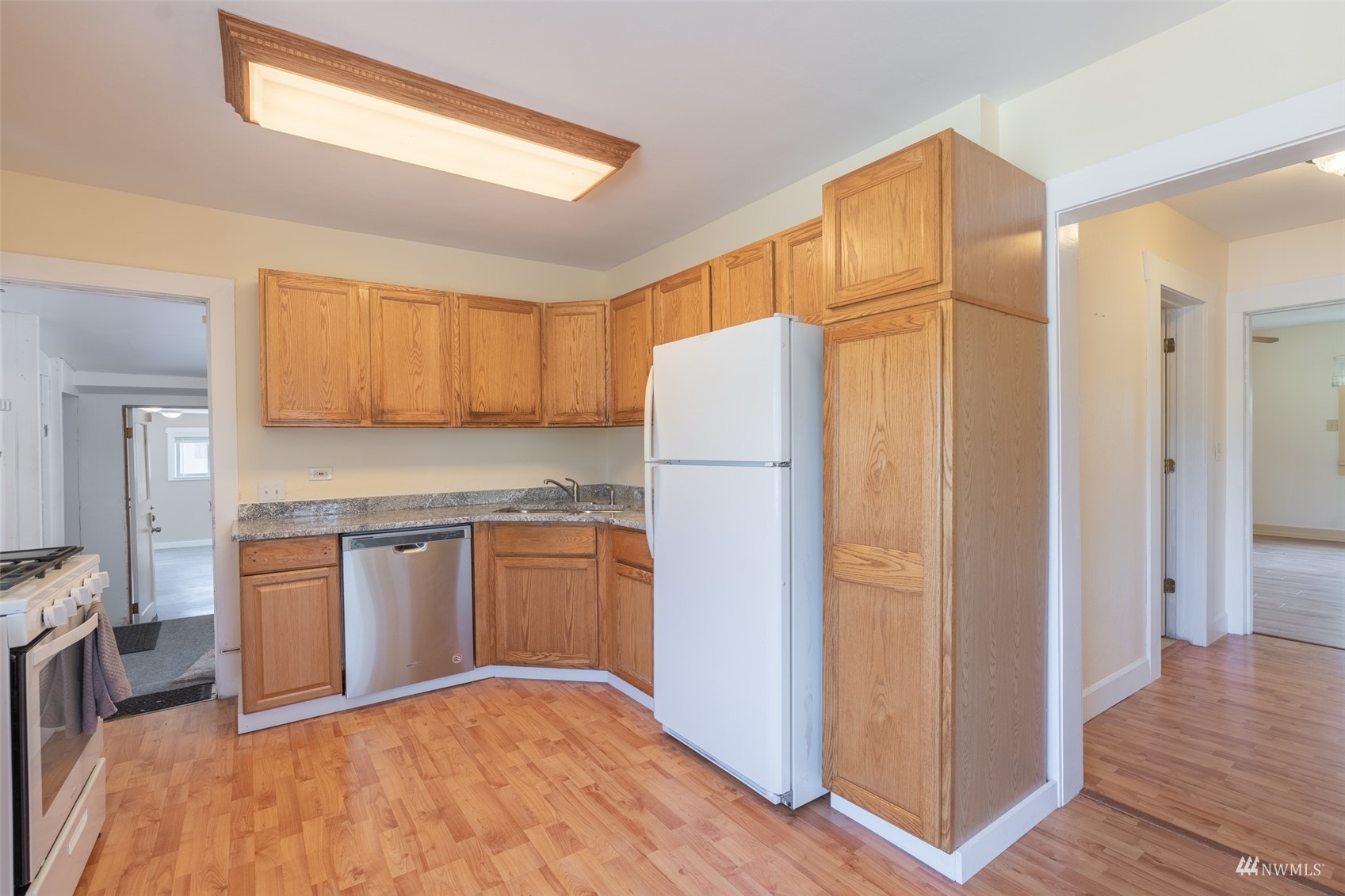 5415 Parker Road East Sumner, WA 98390 - Photo 7 of 27 a kitchen with stainless steel appliances granite countertop a refrigerator and a stove top oven