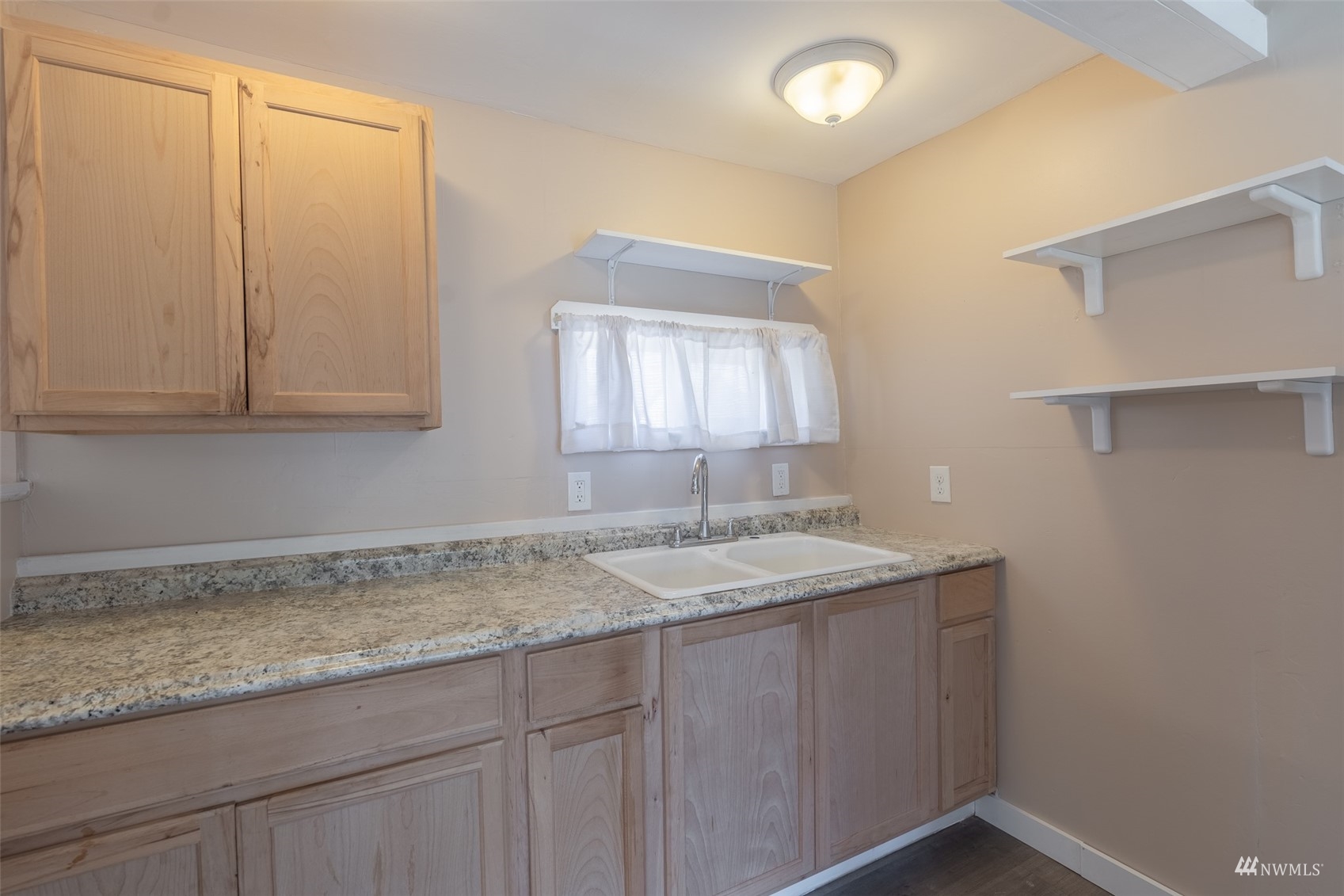 5415 Parker Road East Sumner, WA 98390 - Photo 9 of 27 a bathroom with a granite countertop sink and mirror