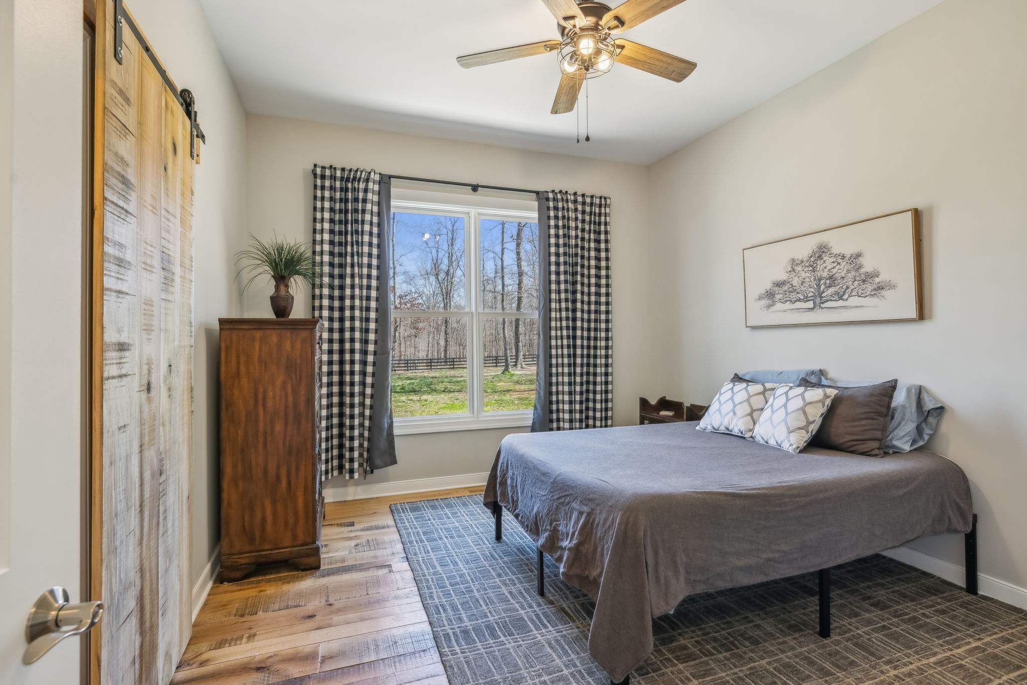 6033 Vesper Way Franklin, TN 37064 - Photo 55 of 83 a bedroom with a large bed and a chandelier