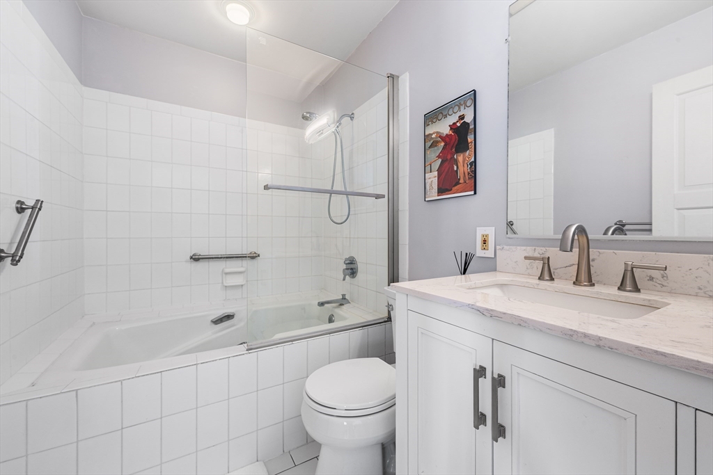 63 Garden Road, Unit C5 Wellesley, MA 02481 - Photo 16 of 30 a bathroom with a granite countertop sink a toilet and a bathtub