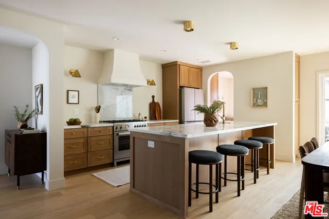 a kitchen with sink cabinets and dining table