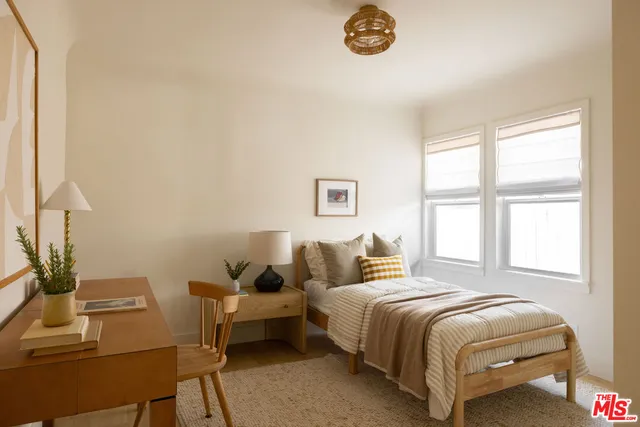 a bedroom with a bed and a table