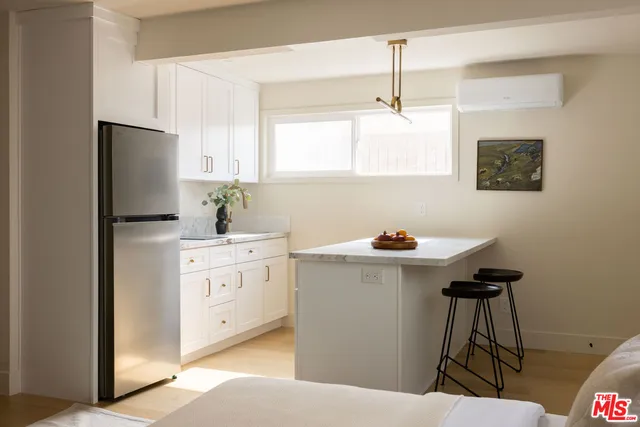 a kitchen with stainless steel appliances a sink a refrigerator and a stove