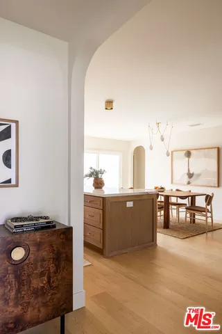 a kitchen with stainless steel appliances granite countertop a sink and stove with wooden floor