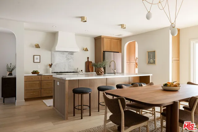 a kitchen with a table chairs sink and cabinets