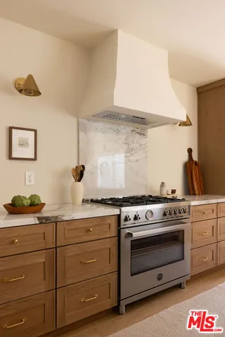 a kitchen with a stove and cabinets