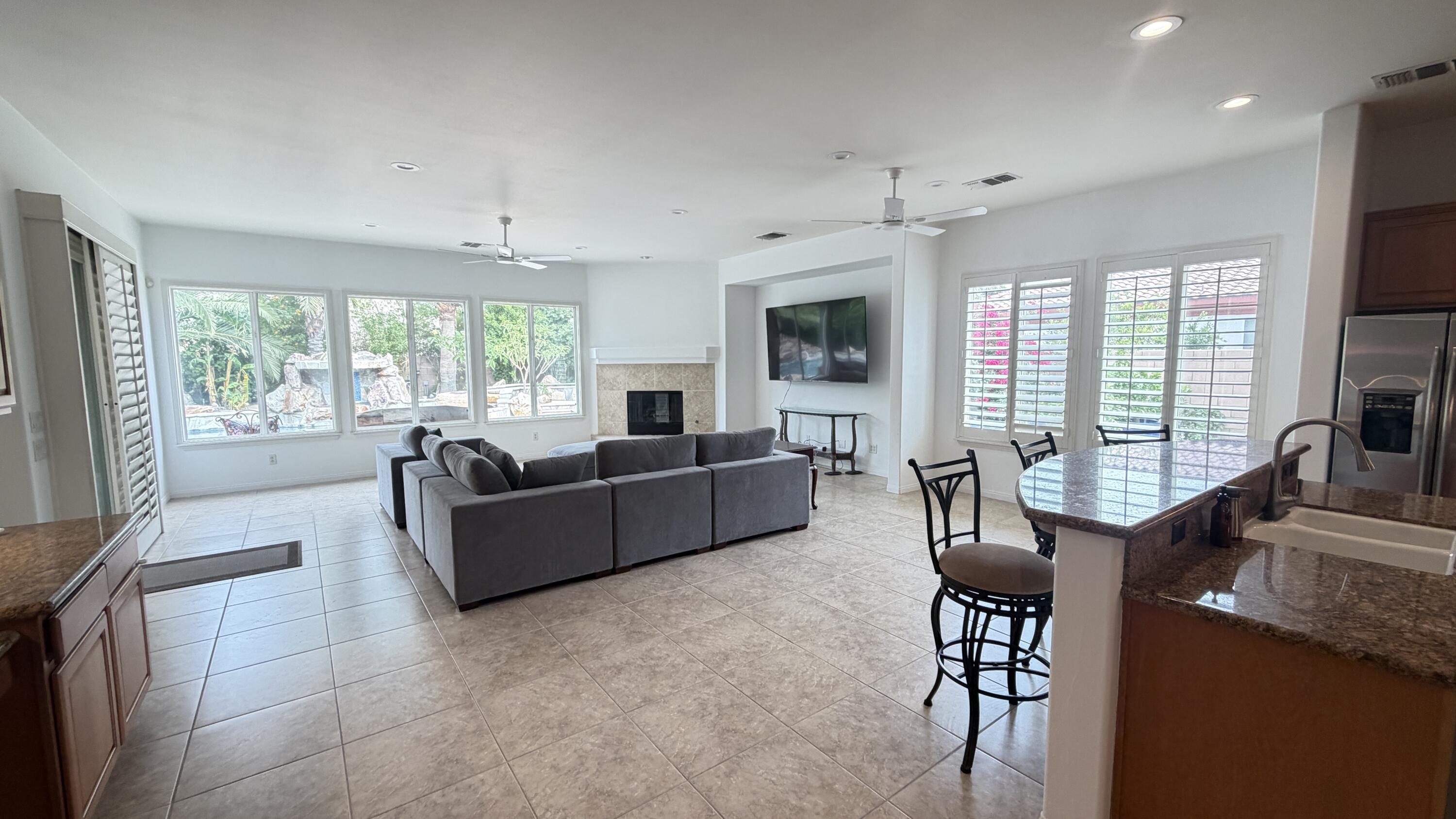49578 Colorado Street Indio, CA 92201 - Photo 12 of 37 a living room with furniture and a flat screen tv