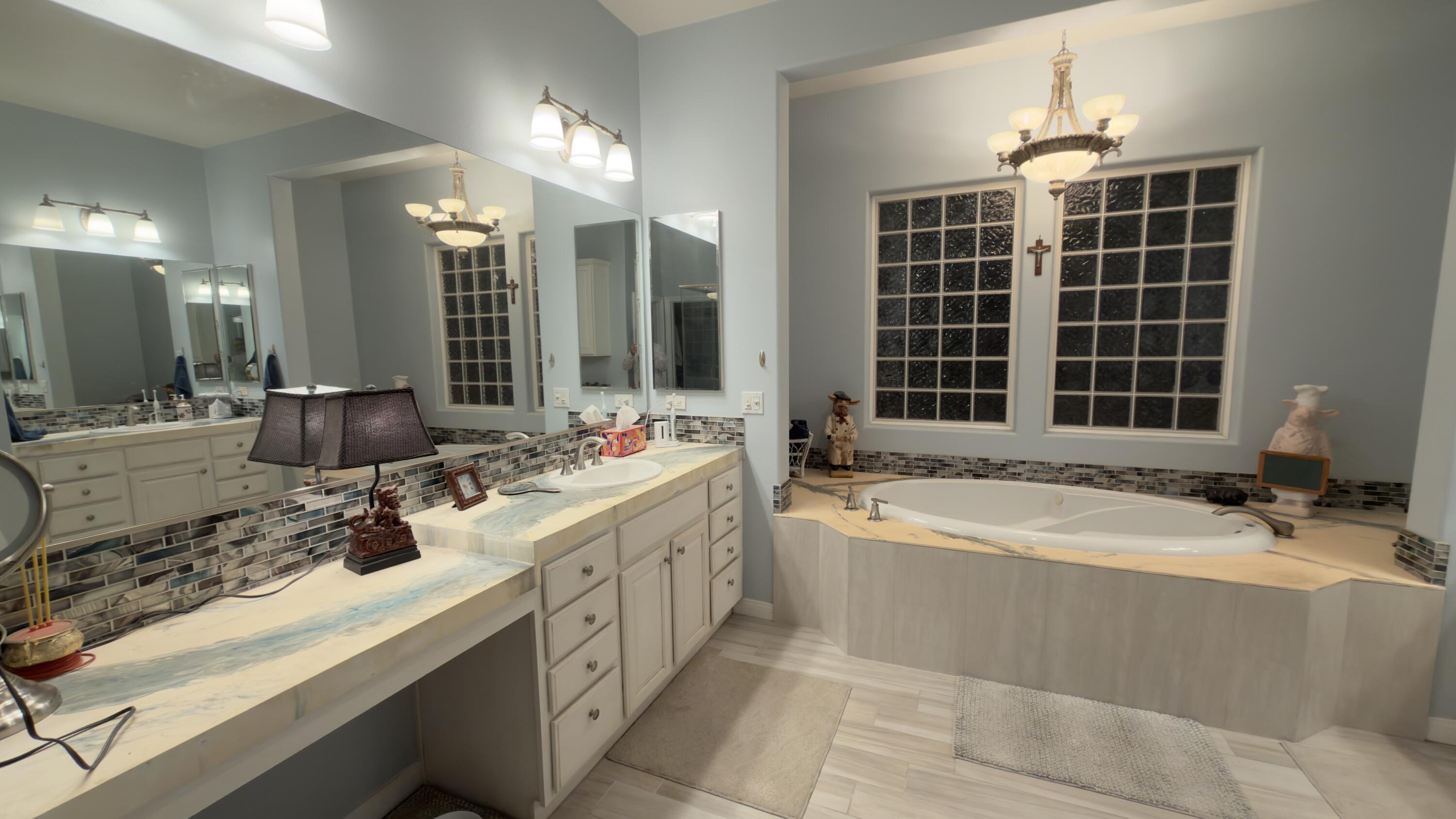 49578 Colorado Street Indio, CA 92201 - Photo 18 of 37 a bathroom with a tub sink and mirror