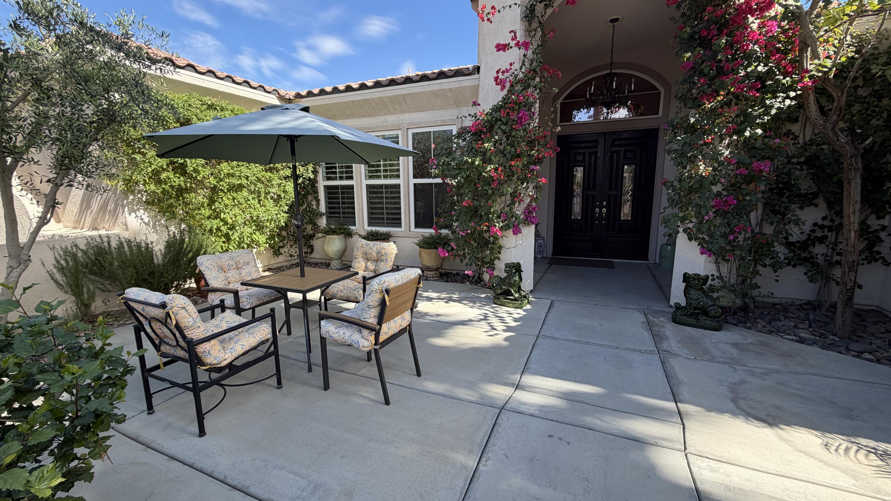 49578 Colorado Street Indio, CA 92201 - Photo 34 of 37 a view of a patio with table and chairs under an umbrella