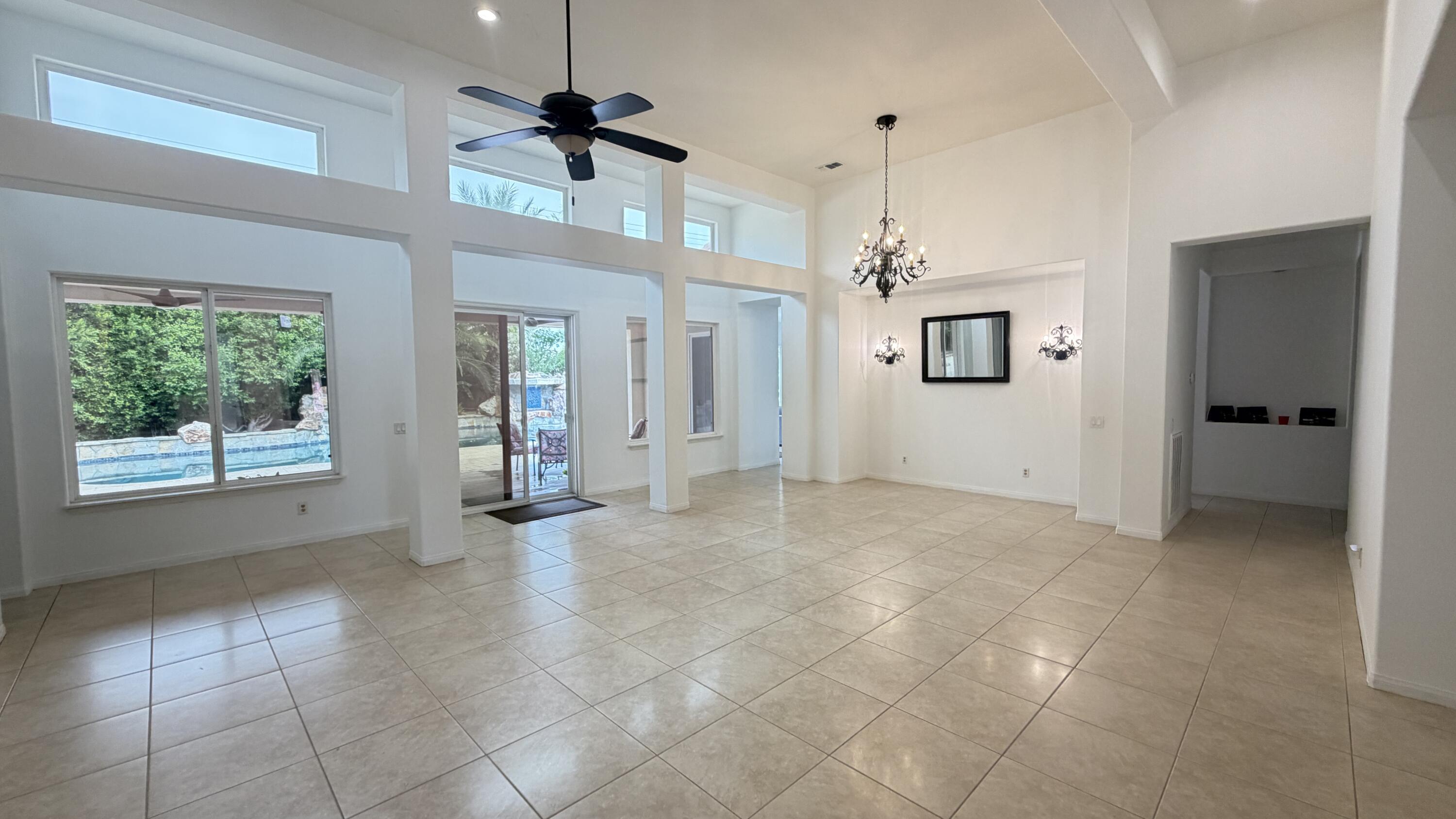 49578 Colorado Street Indio, CA 92201 - Photo 5 of 37 a view of a hallway with windows and chandelier